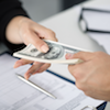 Woman employee handing a man money for loan.